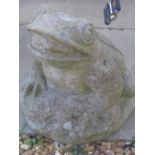 A garden ornament of reconstituted stone in the form of a frog 43cm high