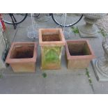 Three terracotta garden planters of square form - largest 41cm x 41cm x 51cm high