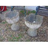 A pair of reconstituted stone planters with foliate decoration - 58cm high x 50cm diameter