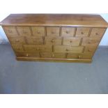 A modern pine bank of eighteen drawers - Height 94 cm x Width 1.