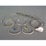 A quantity of seven silver bracelets, a chain with heart pendant,