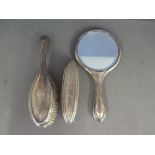 A silver hallmarked dressing table set including hand mirror - mark for Birmingham 1932 and two