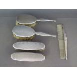 A silver hallmarked dressing set consisting of comb and four brushes - Hallmark Birmingham 1930 -
