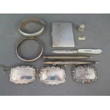 A mixed quantity of silver items including a Sherry, Whisky and Port tag, two bracelets,