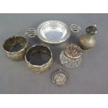 An assorted lot of silver including tea strainer and bowl, napkin rings, pepper, sports medal,