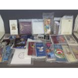 A collection of Royal Mint proof coins and commemorative coins in presentation packaging