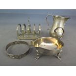 A silver hallmarked small sauce boat markings for 1773, a hallmarked silver toast rack,