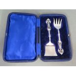 A pair of silver hallmarked Art Nouveau design two piece serving set including fork by James Deakin