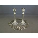 A pair of silver candlesticks - Hallmarked Birmingham 1956 - 57 - weighted and a white  metal belt