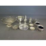 An assortment of silver hallmarked items including mustard, salts, peppers, small tray,