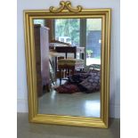 A modern gilt rectangular mirror with mo