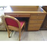 A walnut veneered five drawer desk with