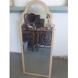 A shabby chic shaped mirror with bevel e