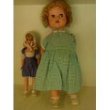 A Palitoy walking doll 51cm tall - arm dislodged - and a smaller walking doll 36cm tall - some