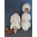 An Armand Marseille porcelain headed Doll - mould no 390 dressed with stand - needs head,