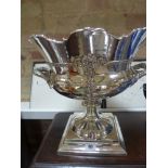 A silver plated champagne bucket/punch bowl on square base