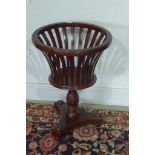 A mahogany basket jardiniere stand