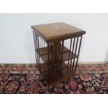 A mahogany Edwardian style revolving bookcase with marquetry,