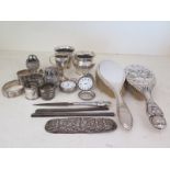 A selection of silver hallmarked items - including napkin rings, cups, small trophy, hairbrushes,