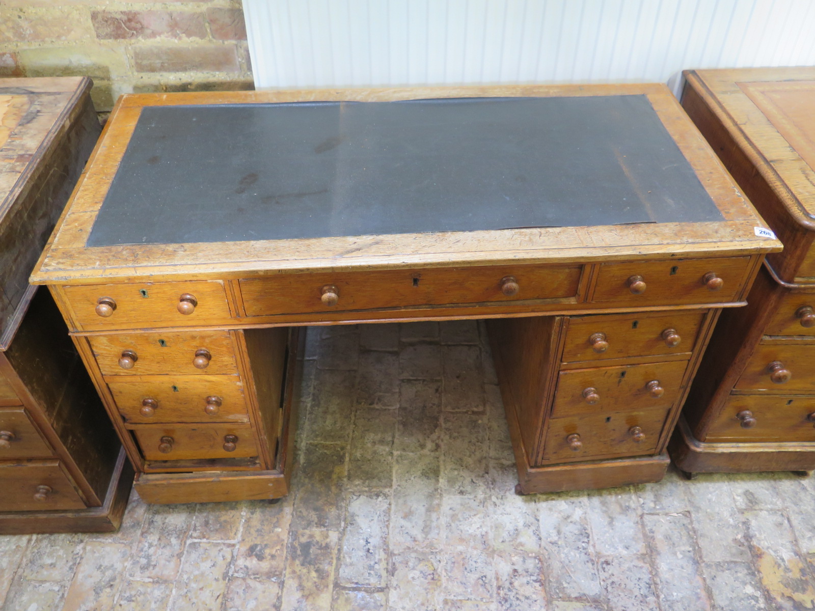 A 19th century oak desk with an inset top over nine drawers - 116cm x 57cm - Removed from a