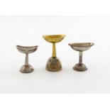 Three 19th century eye baths / scent funnels, comprising: a French silver example, oval form, pull-