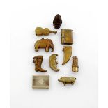 A collection of ten base metal vesta cases, comprising: a seated Buddha, a standing pig, a violin,