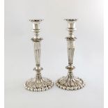 A pair of Victorian electroplated candlesticks,  tapering circular form, fluted decoration, on a