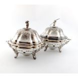 A pair of Victorian old Sheffield plated vegetable dishes and covers on warming stands, with