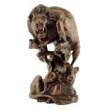 A late 19th century carved wood group of a lion and lioness, the roaring lion crouching on a rocky