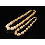 λ Two late 19th century ivory graduated bead necklaces. (2)