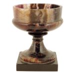 A 19th century Blue John tazza, mounted on a later base, 11.1cm high, 9.4cm diameter.
 
Lot