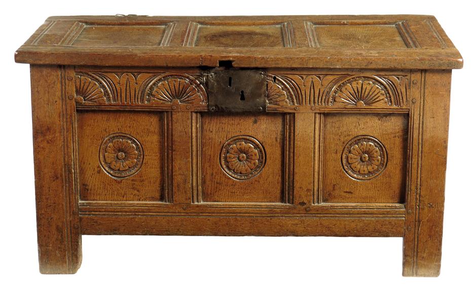 An early 18th century oak triple panelled chest, the interior with a till, the front carved with