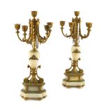 A pair of French gilt brass and onyx candelabra in Louis XVI style, each with five lights with urn