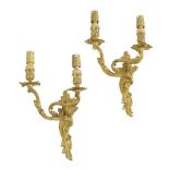 A pair of French ormolu twin light wall appliques in Louis XV style, decorated with scrolling
