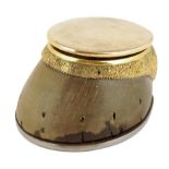 A horse's hoof and gilt brass mounted inkwell, the hinged cover revealing a detachable cut glass