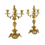 A pair of French ormolu and porcelain mounted four light candelabra in Louis XV style, each with