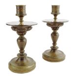 A pair of late Regency bronze candlesticks, with later glass drip pans, 16.8cm high, 8.5cm diameter.