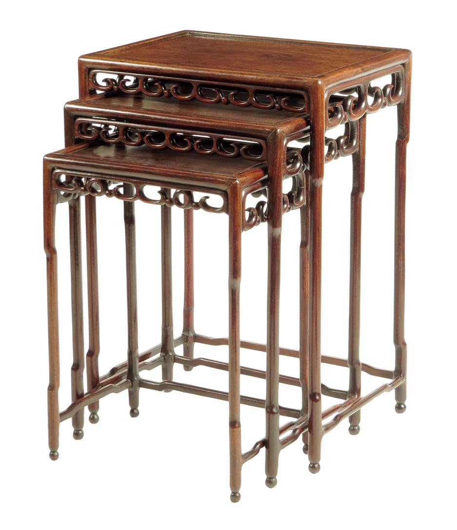 A nest of three Chinese padouk occasional tables, each with fret carved friezes on stretchered