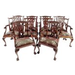 A set of ten mahogany open armchairs in mid 18th century style, the leaf and scroll carved back with