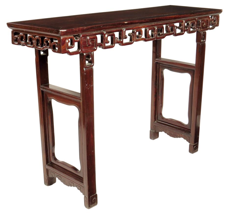 λ A Chinese rosewood altar table, the panelled top above a carved fret frieze, on open panelled legs