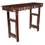 λ A Chinese rosewood altar table, the panelled top above a carved fret frieze, on open panelled legs