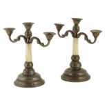 λ A pair of early 20th century Scandinavian hammered pewter and narwhal tusk mounted candelabra,