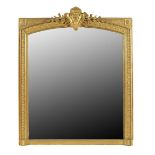 A late 19th century French giltwood and composition overmantel mirror, the arched plate with a