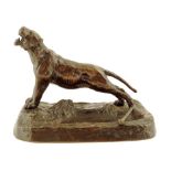 A late 19th century bronze desk stand, modelled with a roaring lion on a naturalistic base,