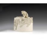 λ A Japanese carved ivory box and cover, decorated with tigers, late 19th / early 20th century, 9.