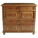 A late 17th century oak chest, the moulded edge top above four long drawers with panelled fronts,