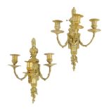 A pair of French ormolu wall lights in Louis XV style, each with a fluted pilaster back plate with a