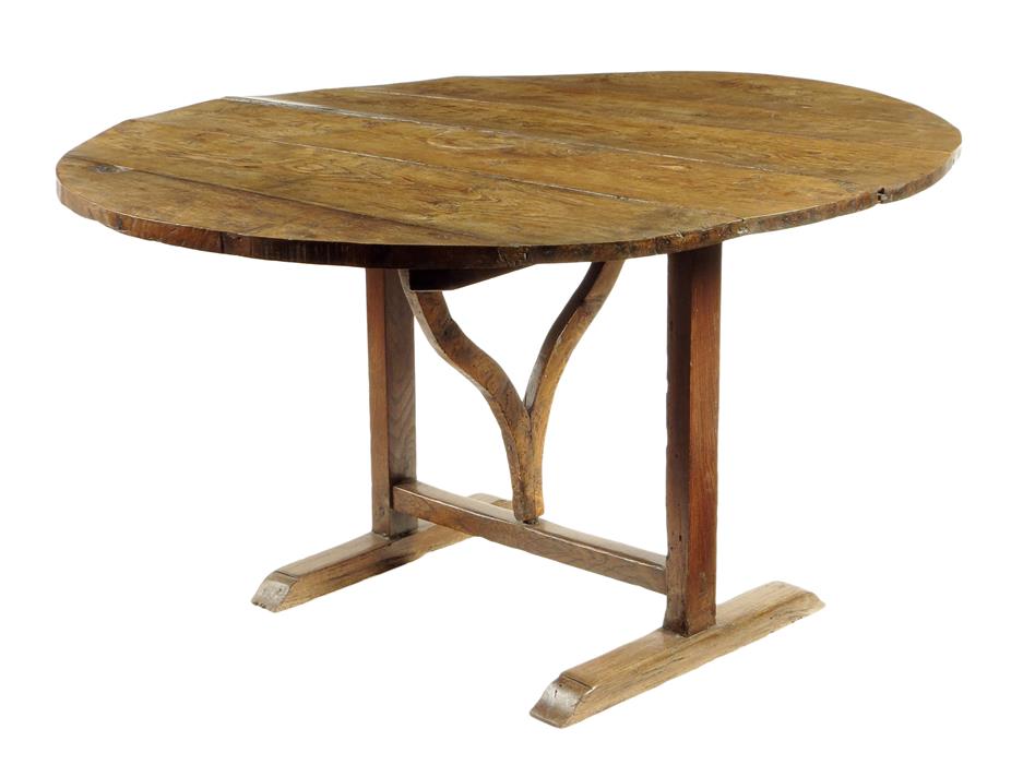 A 19th century French oak vendange table, the circular boarded tilt-top on a bow support and