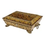 A Regency penwork sarcophagus shape work box, decorated with leaves and flowers with a paper lined