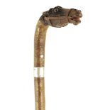 A late 19th century briar riding crop, the handle well carved and painted with a horse's head with